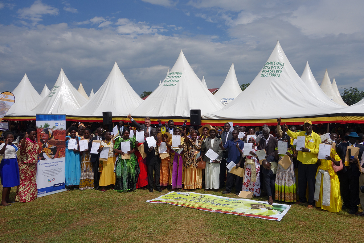 Beneficiaries pose for a photo with the Ambassador of the Netherlands, UN-Habitat Director of External Relations and the Land and GLTN Unit Leader in Adjumani District