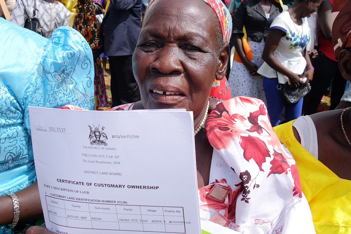 One of the beneficiaries in Adjumani showing her certificate during the issuance ceremony