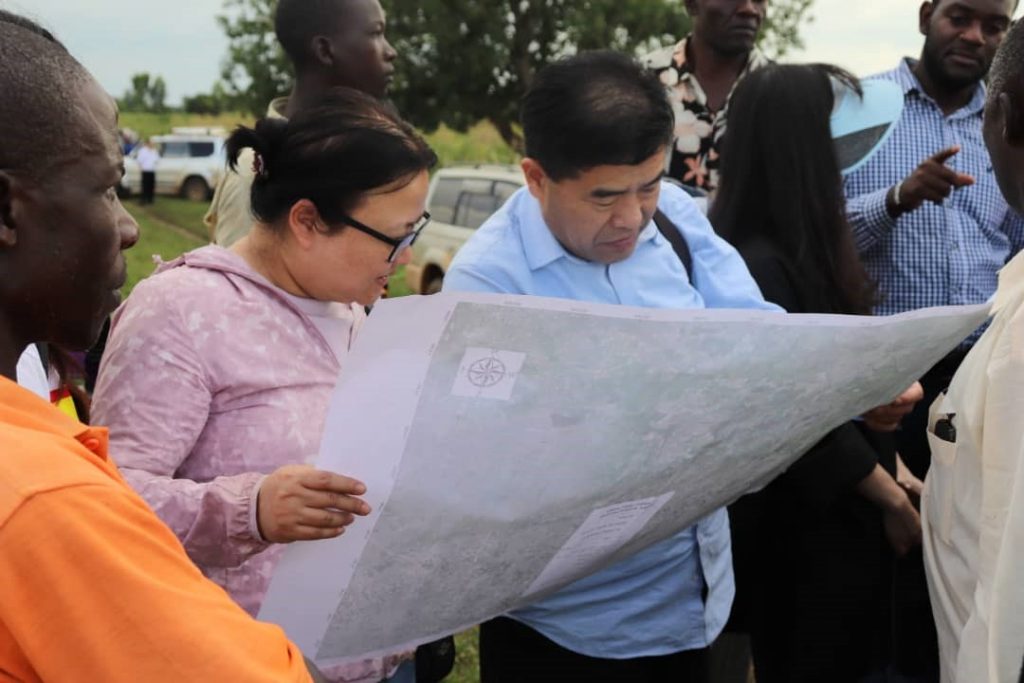 Mr. Gao Yinli and Ms. Xin Lixuan study a Wetland Management Plan of Nasinyi Wetland in Butaleja district, Uganda