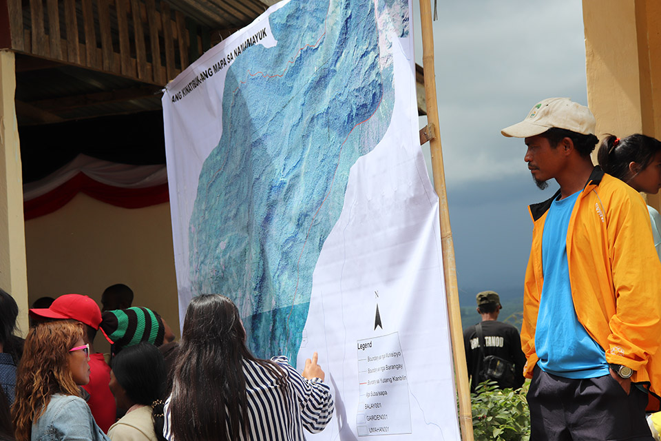 Community viewing the printed map for NAMAMAYUK generated from the data collected from the settlements